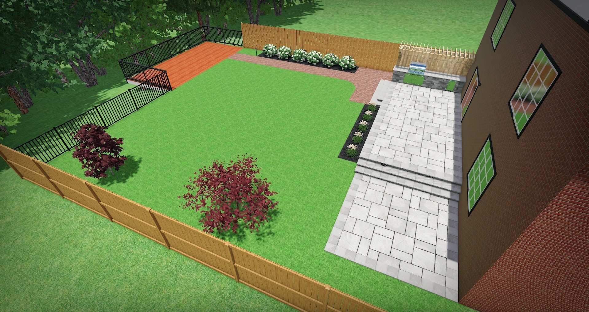 Aerial view of a fenced backyard with a patio, lawn, trees, and a deck, adjacent to a red brick building.